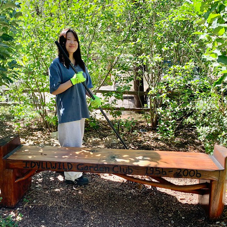 An Art in Society student by the garden club bench.