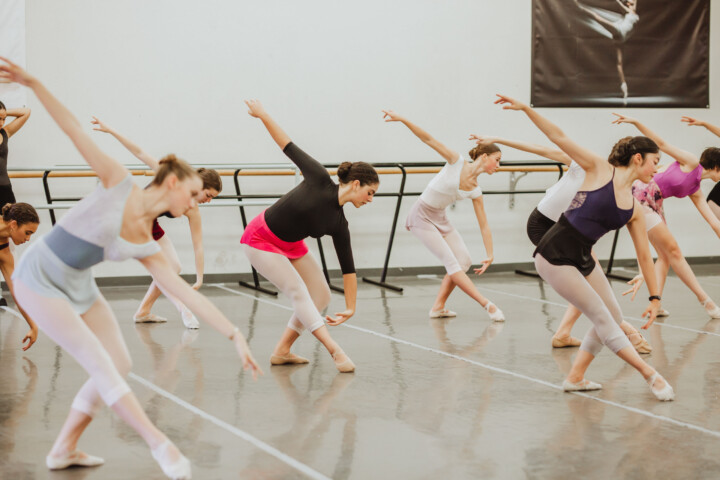 Dancers practicing in a studio.
