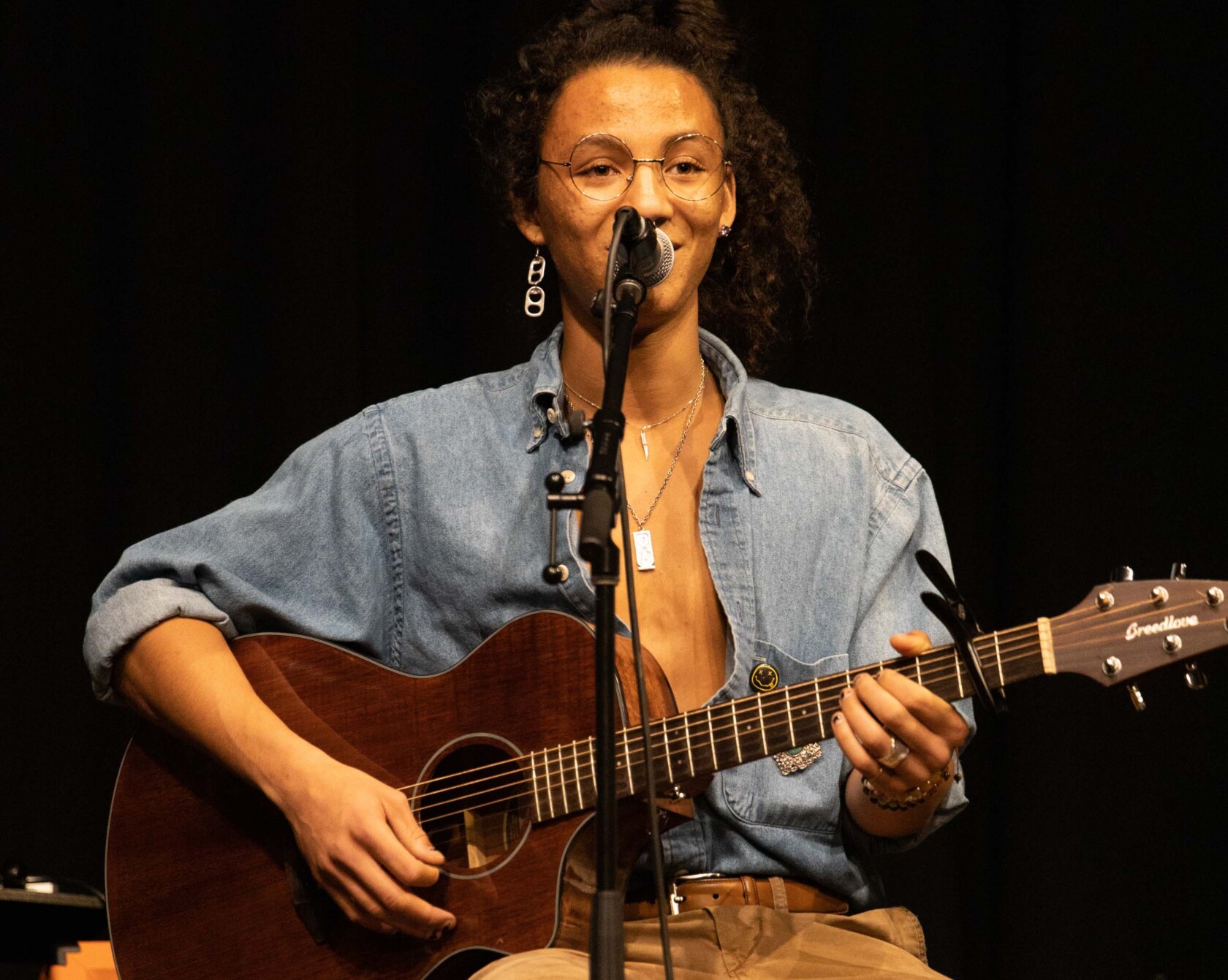 A student performing for a songwriting concert.