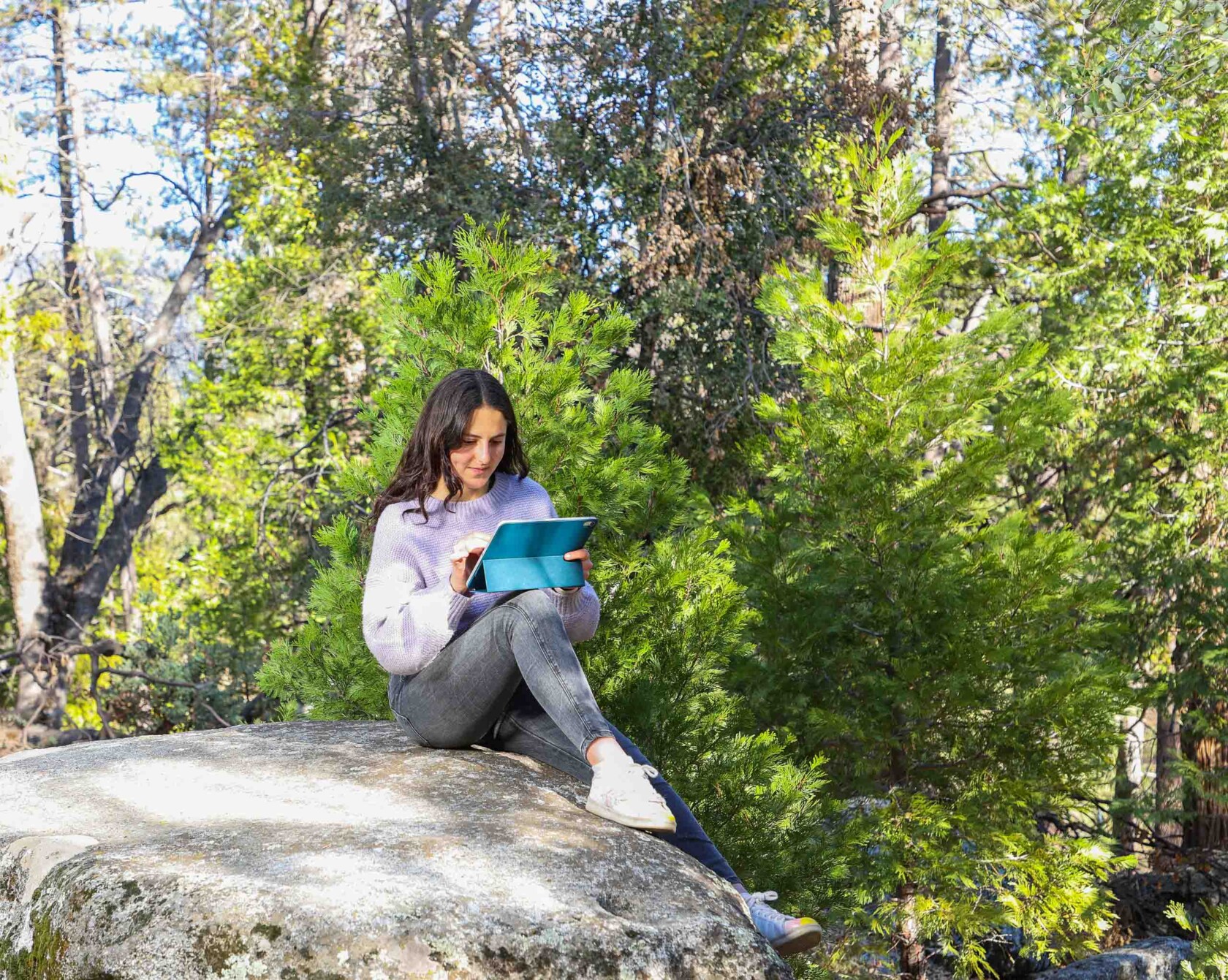 A student using an iPad outside.