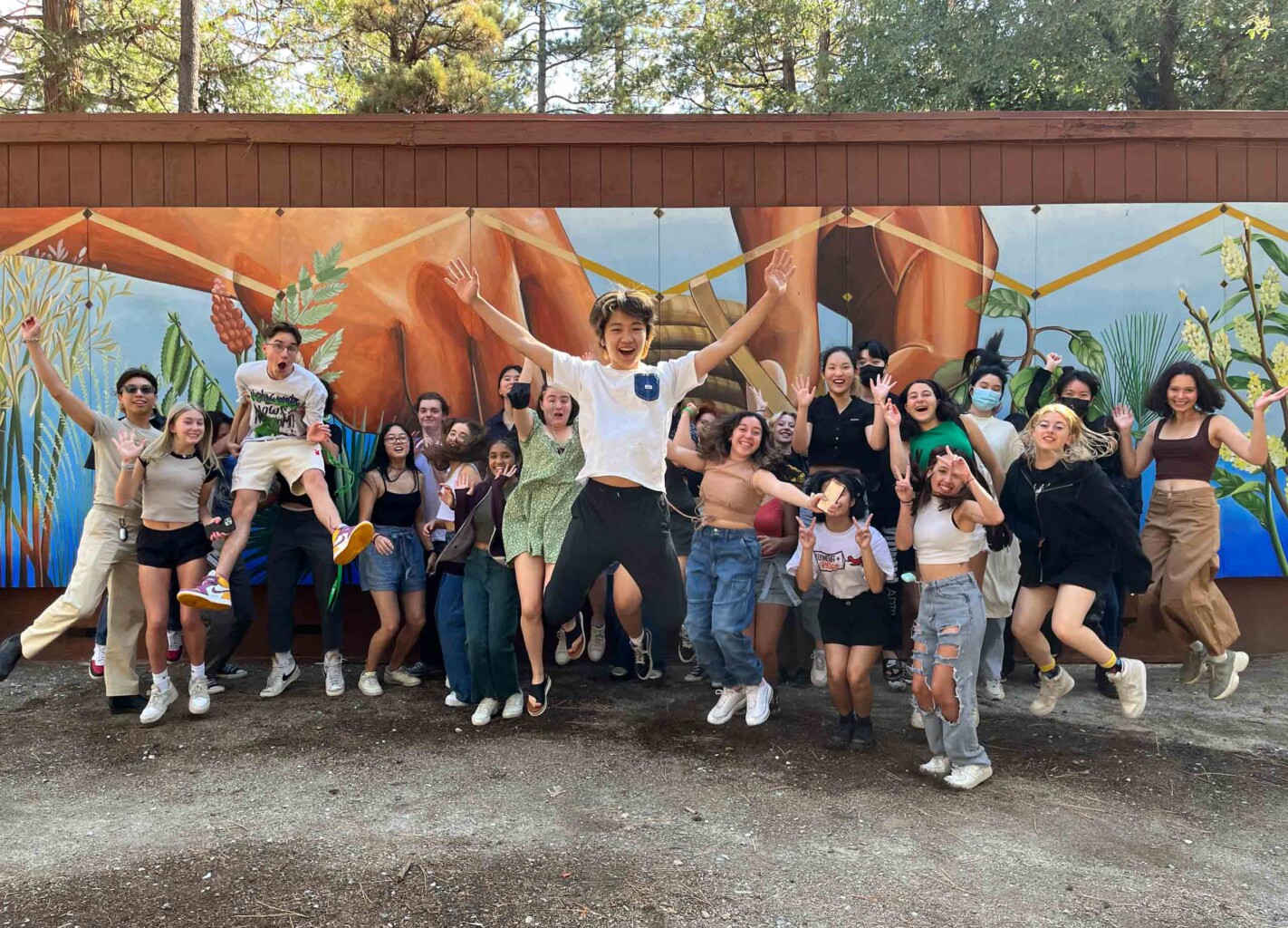 Happy students jumping together.