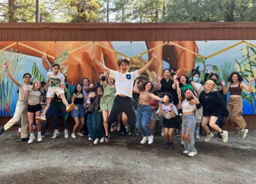 Happy students jumping together.