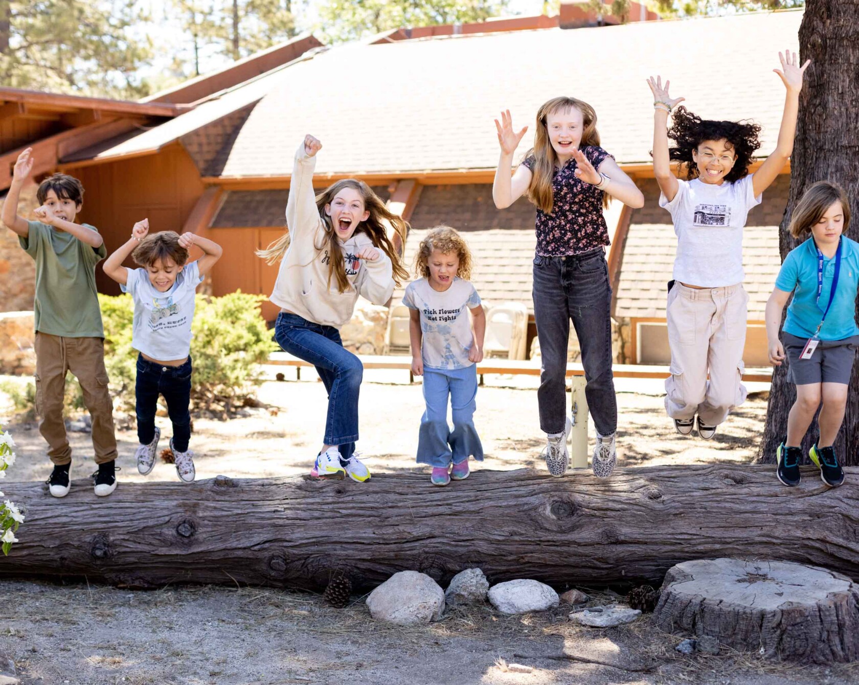 A group of happy kids jumping together.