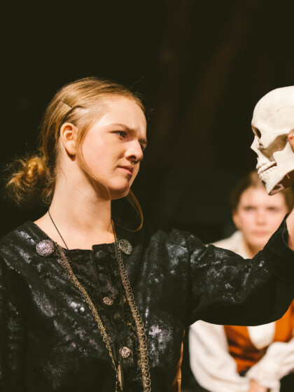 A theatre student acting on stage.