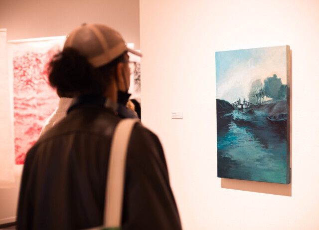 A student admiring a painting.