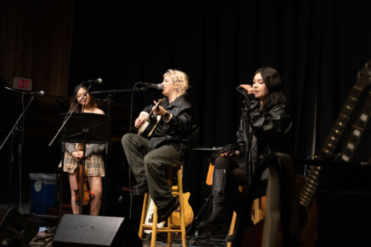 Students performing in a songwriting concert.