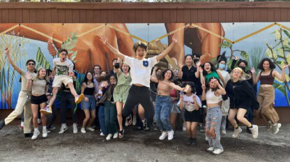 A group of students standing in front of a mural at Idyllwild Arts Academy.